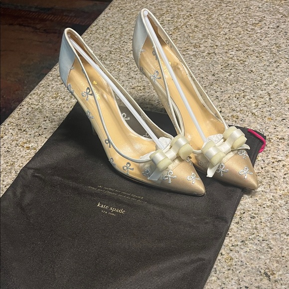 kate spade Shoes - kate spade Metallic Cream and Silver Pointed Bow Pumps